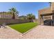Backyard features artificial turf, low maintenance landscape, and covered patio with grill at 3064 E Michelle Way, Gilbert, AZ 85234