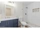Bathroom showcasing a single sink vanity with a tiled shower featuring pebble accents at 3064 E Michelle Way, Gilbert, AZ 85234