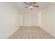 Bedroom featuring neutral carpet, light-colored walls, a ceiling fan, and two doorways at 3064 E Michelle Way, Gilbert, AZ 85234
