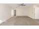 Bedroom featuring neutral carpet, light-colored walls, a ceiling fan, and two doorways at 3064 E Michelle Way, Gilbert, AZ 85234