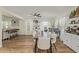 Dining room featuring wood flooring, a large wood table with white chairs, and decor at 3064 E Michelle Way, Gilbert, AZ 85234