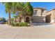 Charming home featuring a well-maintained front yard, neutral stucco exterior, arched entry, and convenient two-car garage at 3064 E Michelle Way, Gilbert, AZ 85234