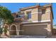 Inviting two-story home features a neutral stucco exterior, arched entry, and convenient two-car garage at 3064 E Michelle Way, Gilbert, AZ 85234