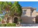 Inviting home featuring a well-maintained front yard, neutral stucco exterior, arched entry, and convenient two-car garage at 3064 E Michelle Way, Gilbert, AZ 85234
