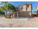 Charming home featuring a well-maintained front yard, neutral stucco exterior, arched entry, and convenient two-car garage at 3064 E Michelle Way, Gilbert, AZ 85234
