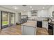 Kitchen featuring a center island, stainless steel appliances, and a sliding glass door to the backyard at 3064 E Michelle Way, Gilbert, AZ 85234