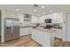 Kitchen featuring a center island, stainless steel appliances, and white cabinetry at 3064 E Michelle Way, Gilbert, AZ 85234