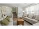 Spacious living room featuring wood flooring, light grey sofas, decor, and a staircase in the background at 3064 E Michelle Way, Gilbert, AZ 85234