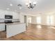 Open concept living area with a modern kitchen, hardwood floors, and natural light streaming through the windows at 3064 E Michelle Way, Gilbert, AZ 85234