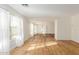 Bright and airy living room features large windows with sheer white curtains, and hardwood floors at 3064 E Michelle Way, Gilbert, AZ 85234