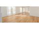 Spacious, light-filled living room features hardwood floors and multiple large windows with sheer white curtains at 3064 E Michelle Way, Gilbert, AZ 85234