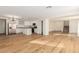 Expansive living area with hardwood floors connecting the kitchen, dining, and living spaces for easy flow at 3064 E Michelle Way, Gilbert, AZ 85234
