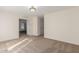 Neutral carpeted loft offers versatile space, with a hallway leading to additional rooms at 3064 E Michelle Way, Gilbert, AZ 85234