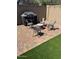 Cozy brick-paved outdoor patio with a fire pit, four chairs, and grill at 3064 E Michelle Way, Gilbert, AZ 85234