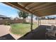 Covered patio overlooking the big backyard with green lawn at 3227 W Kristal Way, Phoenix, AZ 85027