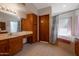 Bathroom showcasing a soaking tub with shower, framed mirror, and oak vanity at 3227 W Kristal Way, Phoenix, AZ 85027