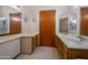 Bright bathroom with double sinks, tile floors and a large mirror at 3227 W Kristal Way, Phoenix, AZ 85027