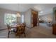 Bright dining room with a round table, wooden chairs, and natural light from the large windows at 3227 W Kristal Way, Phoenix, AZ 85027