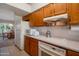 Traditional kitchen featuring wood cabinetry, white appliances, and a tile backsplash at 3227 W Kristal Way, Phoenix, AZ 85027
