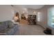 Spacious living room with carpet flooring, bookshelves, and a cozy atmosphere at 3227 W Kristal Way, Phoenix, AZ 85027