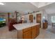 Open concept living area and kitchen with brick fireplace, ceiling fan, and tiled floor at 3227 W Kristal Way, Phoenix, AZ 85027