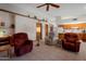 Comfortable living room with neutral tones, featuring a view of the kitchen and a cozy seating arrangement with armchairs at 3227 W Kristal Way, Phoenix, AZ 85027