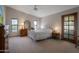 Bright bedroom with a cozy interior, featuring a comfortable bed, dresser, and access to an outdoor patio area at 3227 W Kristal Way, Phoenix, AZ 85027