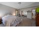 Cozy bedroom featuring neutral tones, comfortable bedding, mirrored closet doors, and ample natural light at 3227 W Kristal Way, Phoenix, AZ 85027