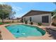 Sparkling pool, green lawn, and neutral colored exterior of this home at 3227 W Kristal Way, Phoenix, AZ 85027