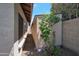 Side yard features a storage shed and a gravel pathway between the house and the perimeter wall at 3227 W Kristal Way, Phoenix, AZ 85027