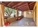View of a covered back patio with string lights, concrete flooring, and partial enclosure at 3842 W Ocotillo Rd, Phoenix, AZ 85019