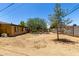 The backyard features gravel landscaping and a fire pit area, all enclosed by a block wall at 3842 W Ocotillo Rd, Phoenix, AZ 85019