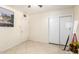 A bedroom showcasing neutral walls, tiled floors, and a closet, offering a clean and simple space at 3842 W Ocotillo Rd, Phoenix, AZ 85019