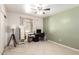 Bright bedroom featuring a ceiling fan, neutral walls, and light-colored tiled floors at 3842 W Ocotillo Rd, Phoenix, AZ 85019