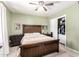 Bedroom with wood-look bed frame, side tables, closet, beige carpet, and a ceiling fan at 3842 W Ocotillo Rd, Phoenix, AZ 85019