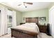 Bedroom with wood-look bed frame, side tables, beige carpet, and a window with natural light at 3842 W Ocotillo Rd, Phoenix, AZ 85019
