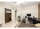 Bedroom featuring a tiled floor, ceiling fan, closet, guitars, and computer setup at 3842 W Ocotillo Rd, Phoenix, AZ 85019