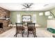 Cozy dining room showcases a brick fireplace, a ceiling fan, and an art piece on the wall at 3842 W Ocotillo Rd, Phoenix, AZ 85019