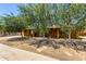 Charming single-story home with mature trees providing shade in the front yard at 3842 W Ocotillo Rd, Phoenix, AZ 85019