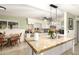 Bright kitchen features tile flooring, granite counters, white cabinets, and a pendant light fixture above the island at 3842 W Ocotillo Rd, Phoenix, AZ 85019