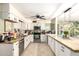 Spacious kitchen with granite countertops, tile flooring, white cabinets, and stainless steel appliances at 3842 W Ocotillo Rd, Phoenix, AZ 85019
