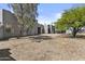 Desert landscaped backyard with a stucco exterior and a variety of trees at 38709 N 16Th Pl, Phoenix, AZ 85086