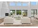 Bright living room offers ample light with fireplace and views of pool and desert landscape at 38709 N 16Th Pl, Phoenix, AZ 85086