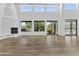 Bright living room with high ceilings, fireplace, and views of the back yard at 38709 N 16Th Pl, Phoenix, AZ 85086