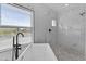 The main bathroom features a luxurious soaking tub, window, and marble tile at 38709 N 16Th Pl, Phoenix, AZ 85086
