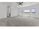Spacious main bedroom featuring carpet floors, ceiling fan and a view to mountains in the distance at 38709 N 16Th Pl, Phoenix, AZ 85086