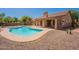 The backyard features a sparkling pool, covered patio, and low-maintenance desert landscaping at 4037 E Milton Dr, Cave Creek, AZ 85331