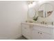Modern bathroom with double sinks, elegant mirrors, and wood-style tile floors at 4037 E Milton Dr, Cave Creek, AZ 85331