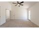Comfortable bedroom featuring carpet, a ceiling fan, and access to the hallway and backyard at 4037 E Milton Dr, Cave Creek, AZ 85331