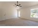 Well-lit bedroom featuring a ceiling fan, carpet, and an outdoor view through a window at 4037 E Milton Dr, Cave Creek, AZ 85331